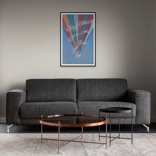 Contemporary Arabic calligraphy artwork framed above a gray sofa in a modern living room.