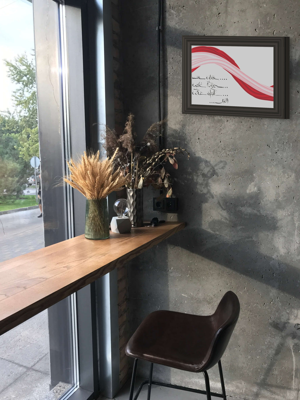 Arabic calligraphy artwork titled “Drunkenness” featuring a handwritten Arabic verse beneath flowing red and pink ribbon-like forms, printed as a fine art giclée on textured paper and displayed in interior spaces.