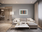 Lebanon art print by ENJZ in a white frame, displayed above a sectional sofa in a grey contemporary living room. Original Arabic poetry by Zein Sourany.