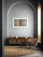 Lebanon art print by ENJZ in a white frame, displayed under a plastered arch above a wood sideboard in a grey tonal interior. Original Arabic poetry by Zein Sourany.